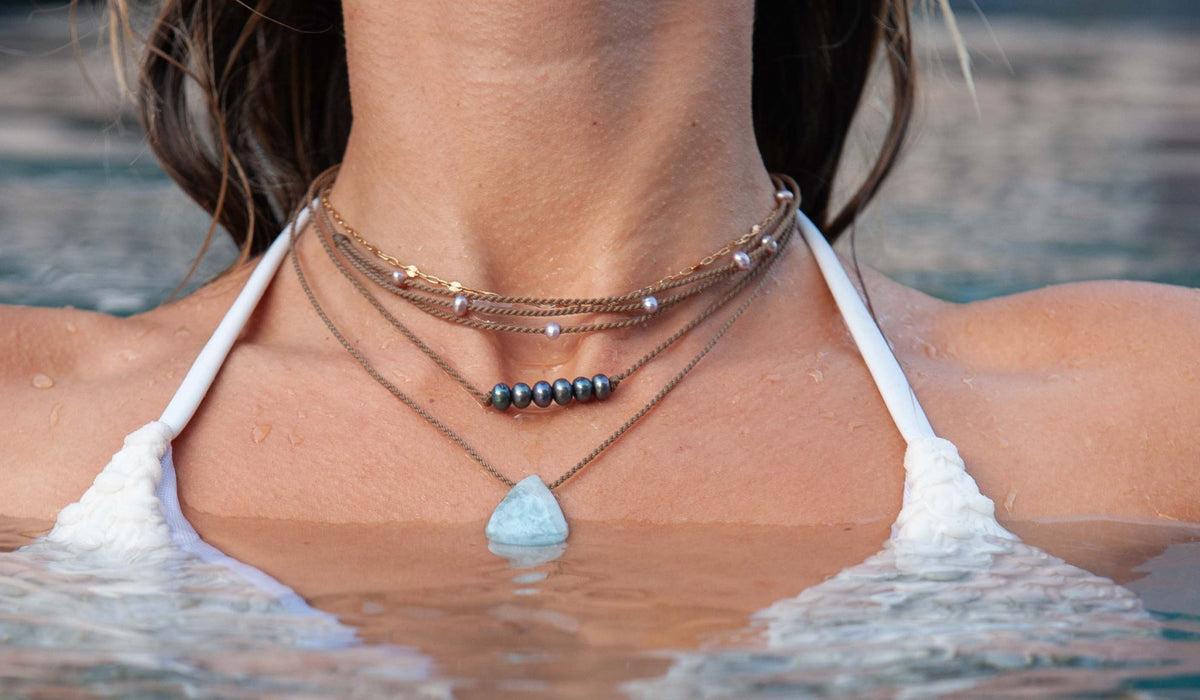 waterproof pearl necklace worn coming out of ocean water