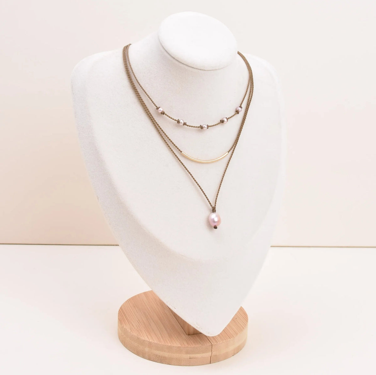 Dripping in Pearls necklace stack in blush on bust with white background