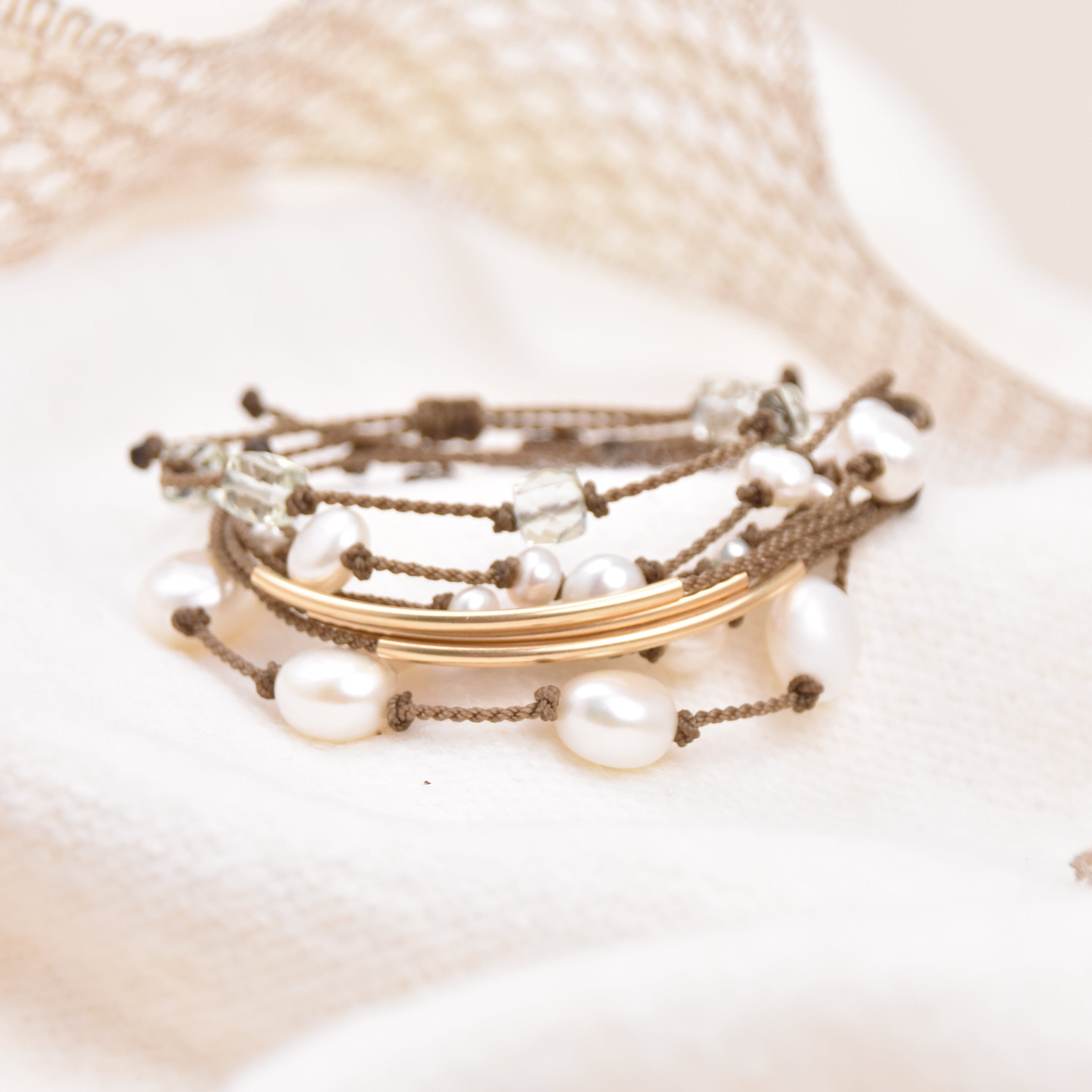 Set of pearl bracelets on a textured surface