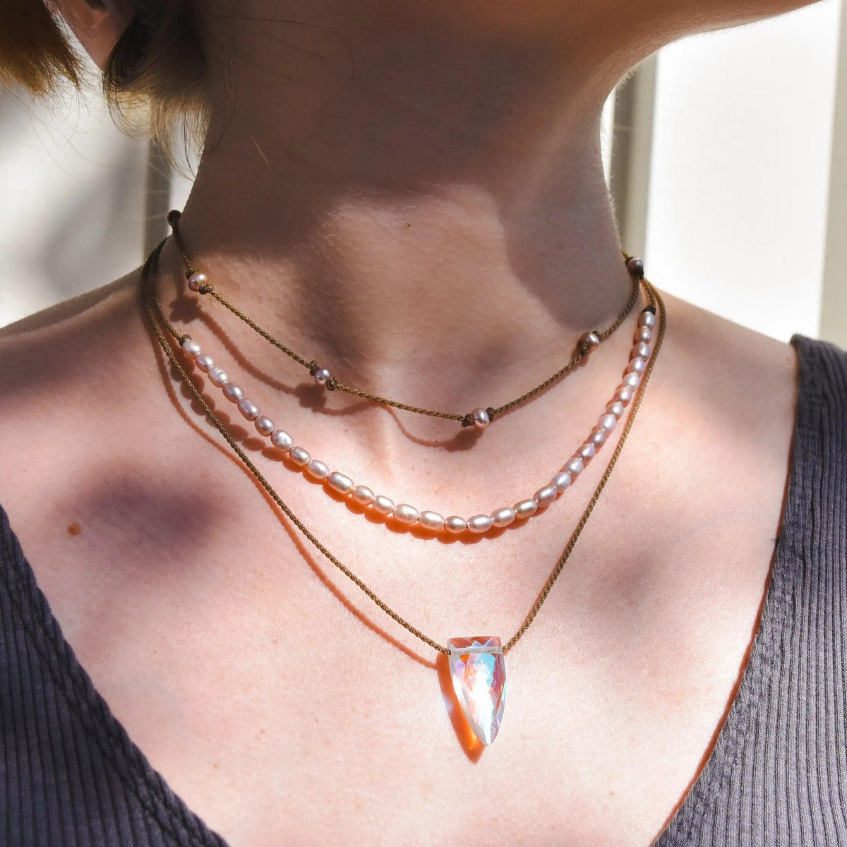 Rosy Aura Necklace Stack in blush on model with white background