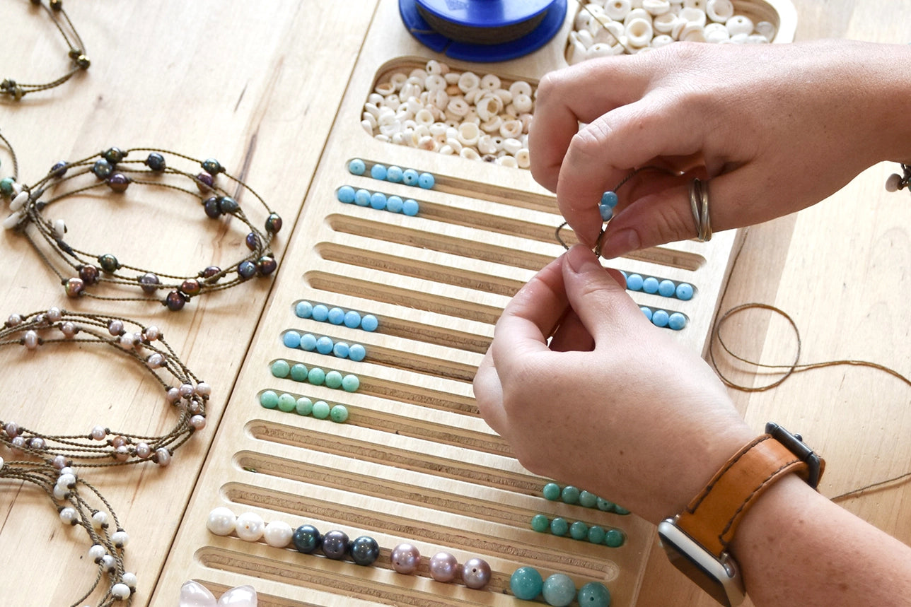 Women handcrafting rope jewelry at Tula Blue, Texas workshop.