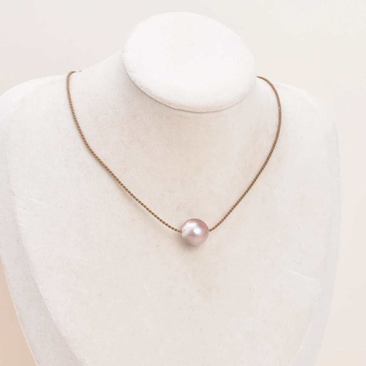 Classic Pearl Necklace without knots, one blush pink Edison freshwater pearl on hand-spun rope, displayed on a bust