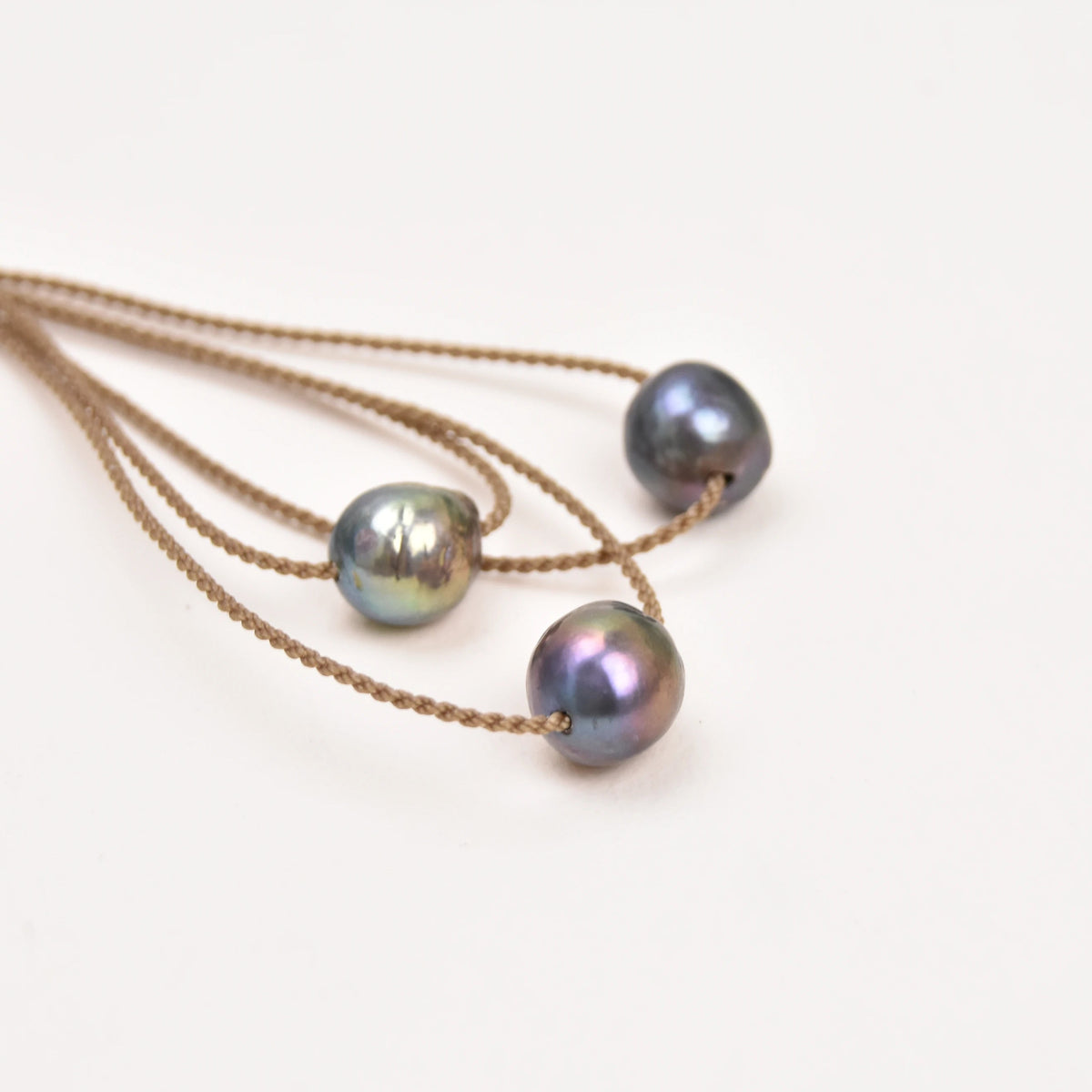 Three Classic Pearl Necklaces without knots, each with a peacock Edison freshwater pearl on hand-spun rope