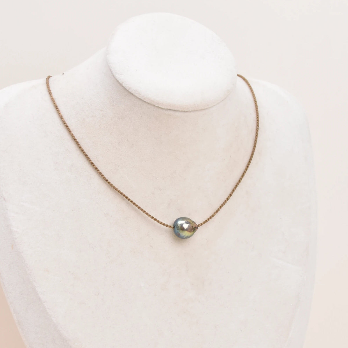 Classic Pearl Necklace without knots, one peacock Edison freshwater pearl on hand-spun rope, displayed on a bust