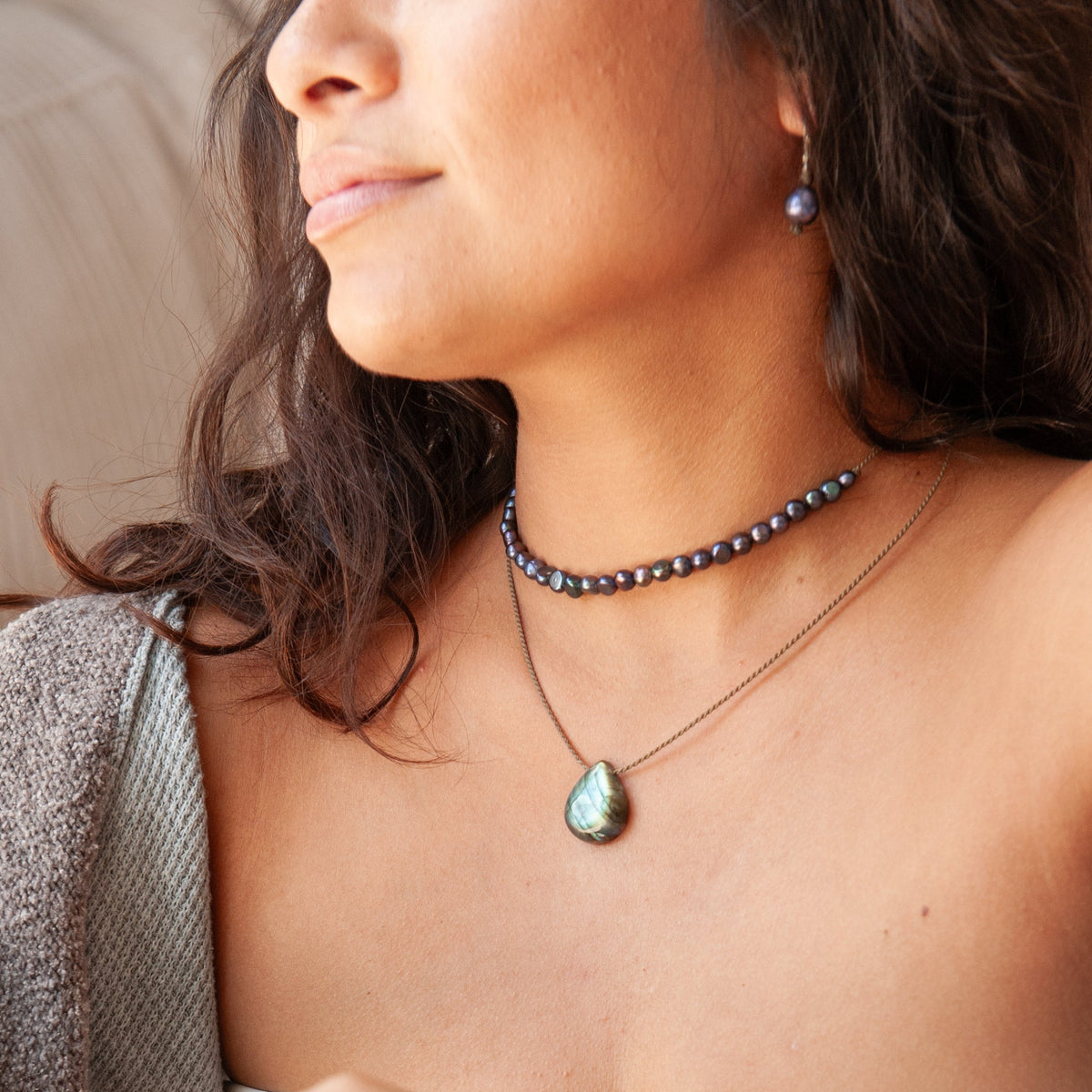 Labradorite Gemstone Pendant with green and blue flash on hand-spun rope, layered with a peacock Crown Pearl Necklace