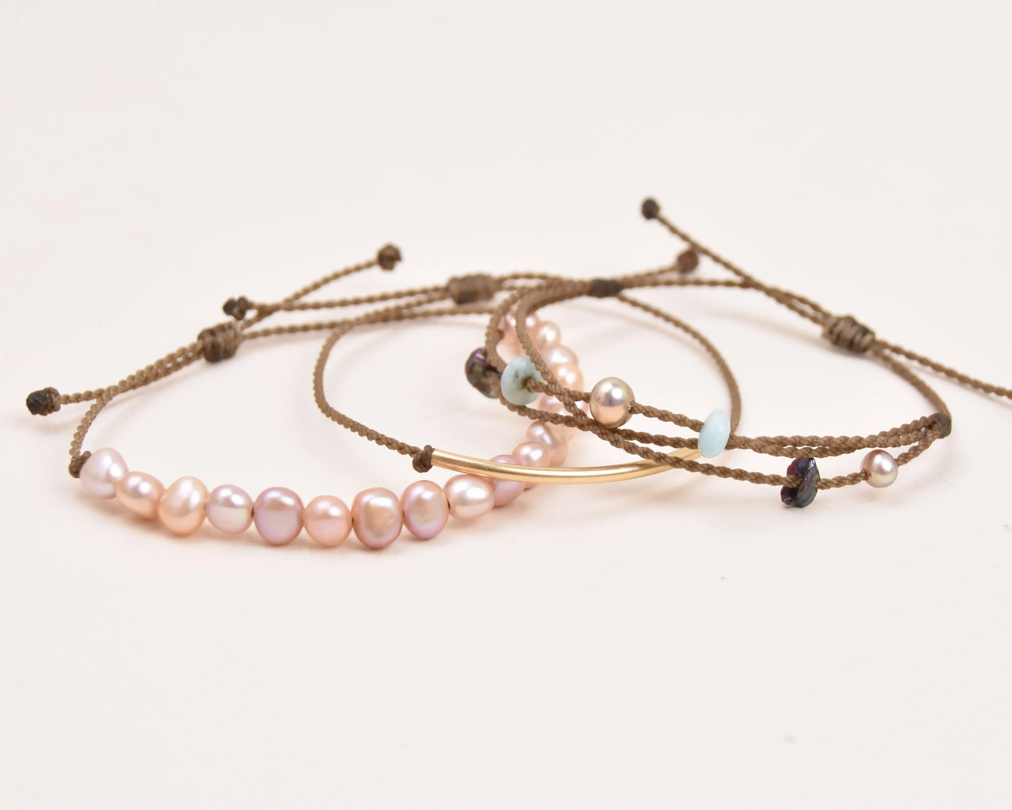 crown of the seven seas bracelet stack in blush layout spread on white background