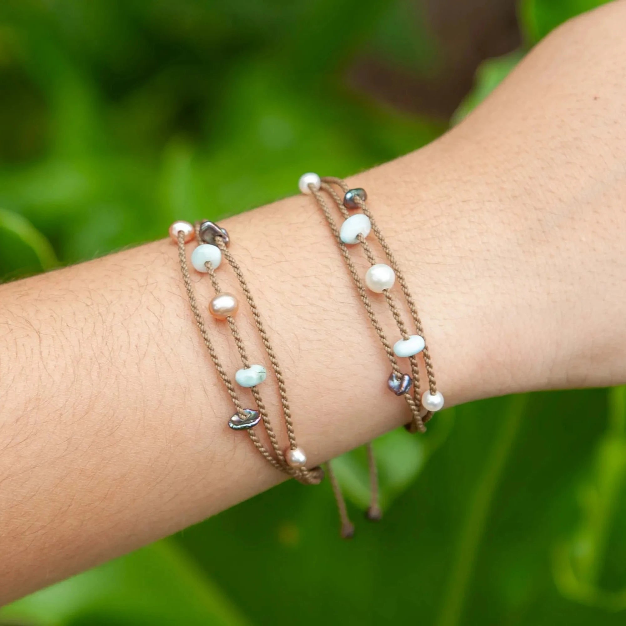 Seven Seas X PADI Riptide Bracelets with blush and white pearls on model wrist