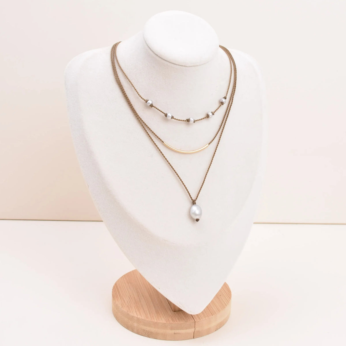 Dripping in Pearls necklace stack in silver on bust with white background