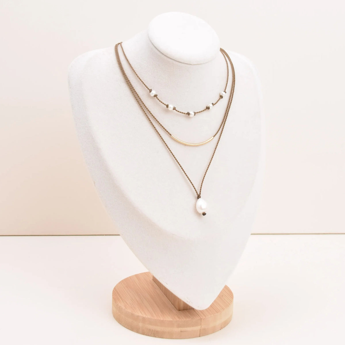 Dripping in Pearls necklace stack in white on bust with white background