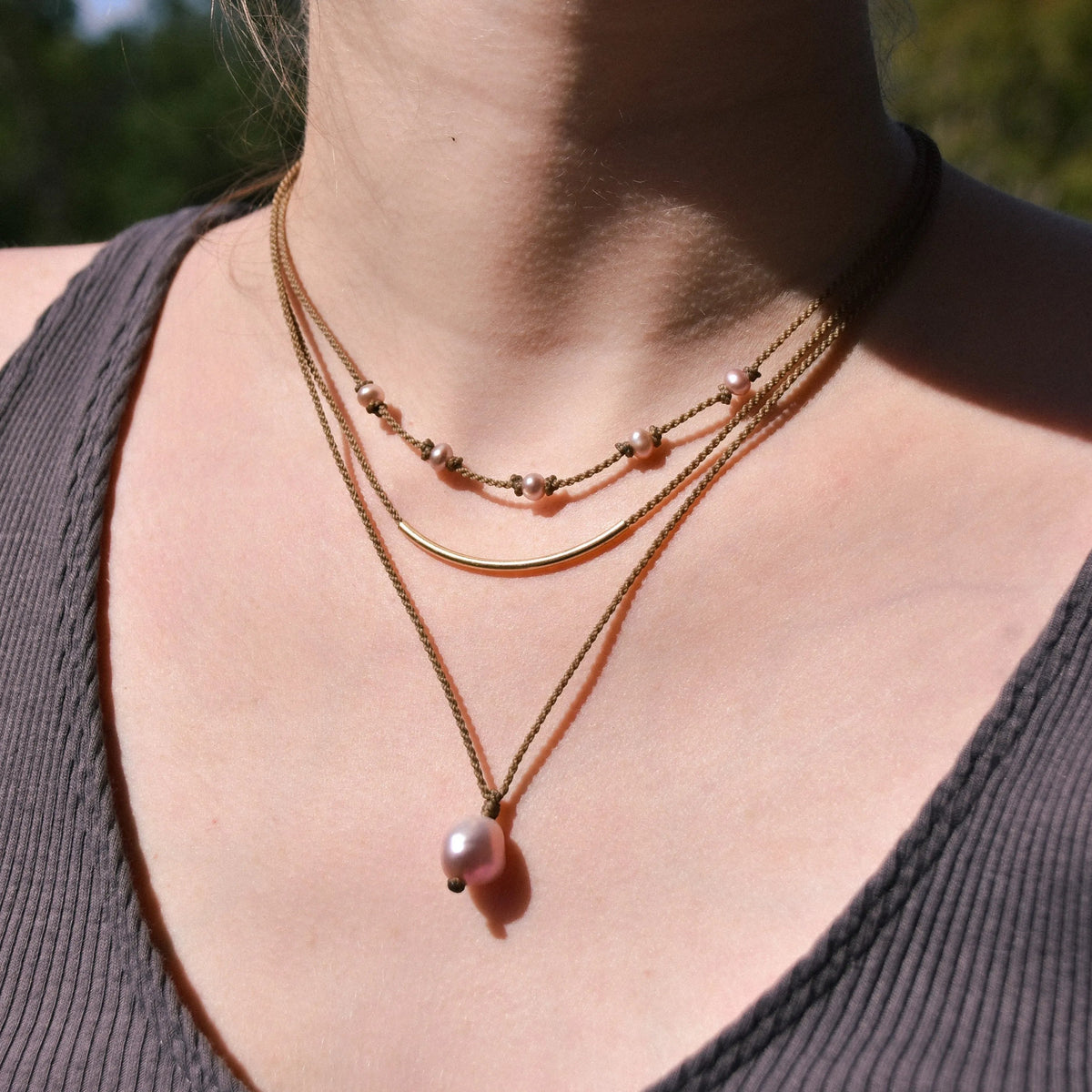 Dripping in Pearls necklace stack in blush on model closeup