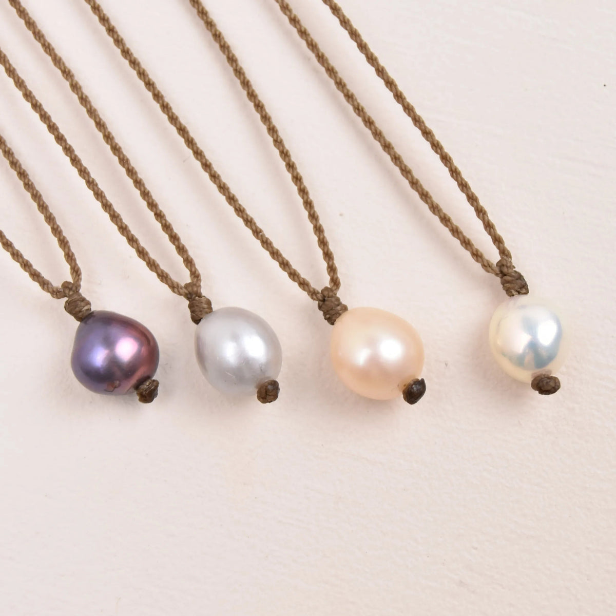 pearl drop necklace layout in peacock, silver, peach and white 