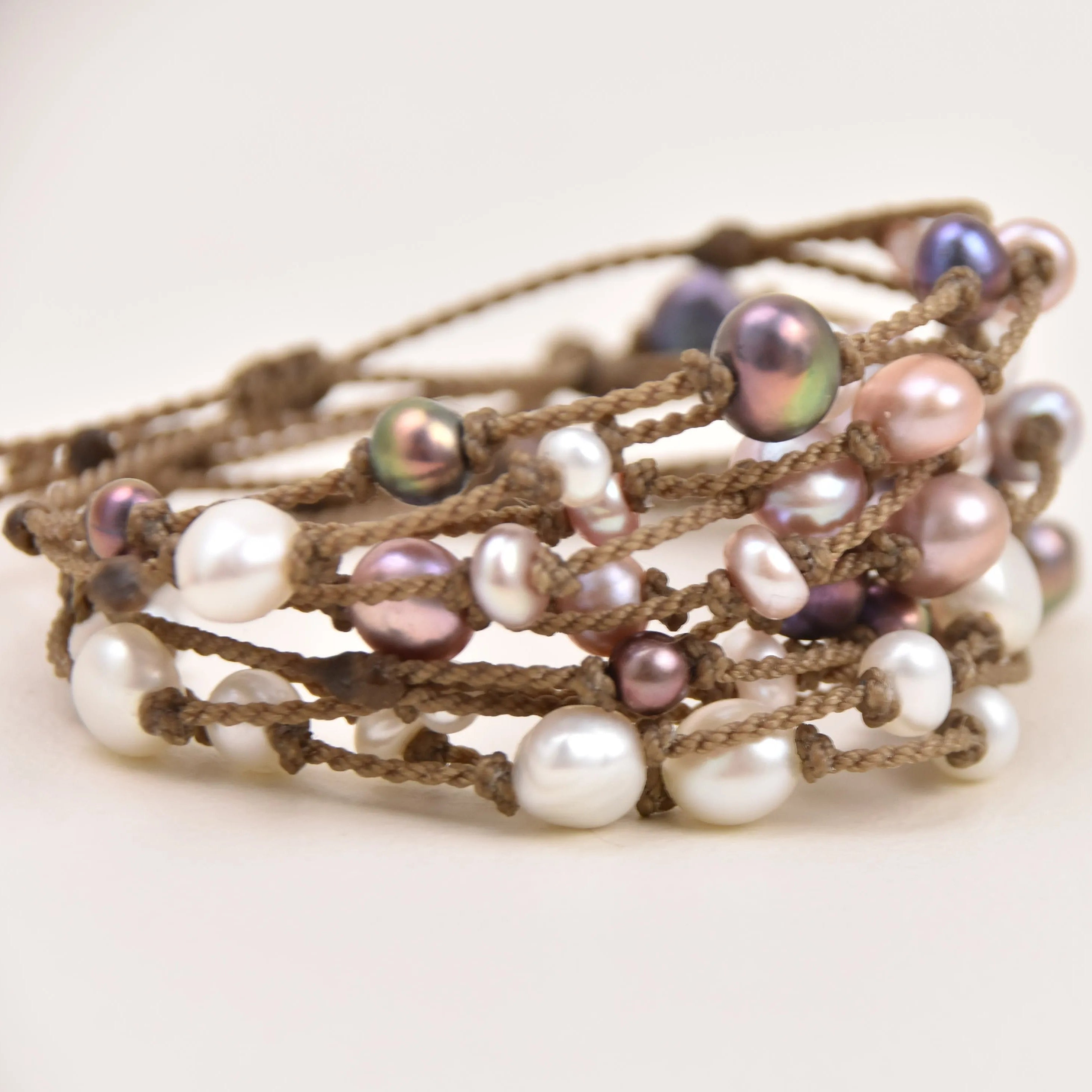 Tula Blue's Journey Bracelet in white blush peacock and mixed pearl stacked
