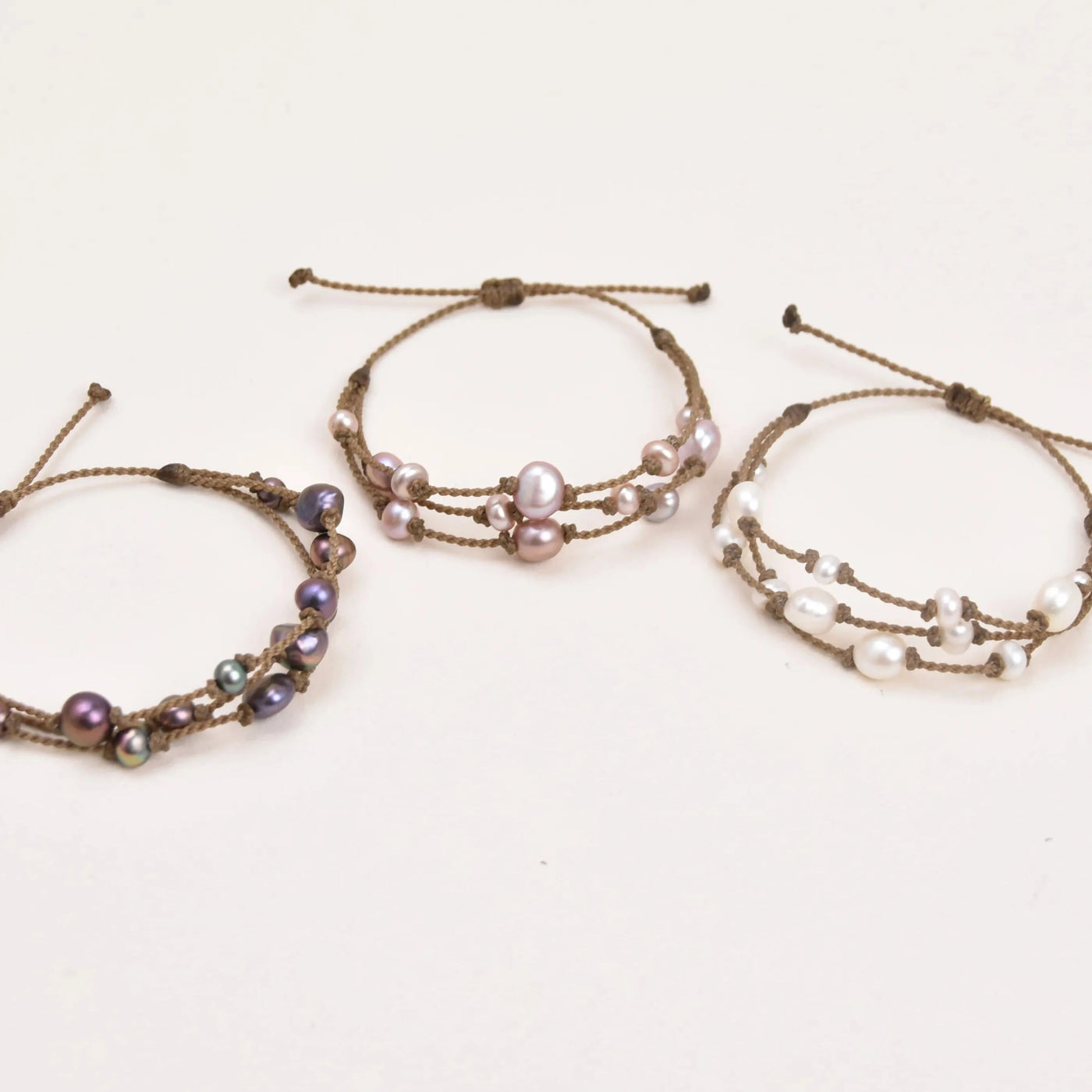 Tula Blue's Journey Bracelet in peacock blush and white pearl trio layout