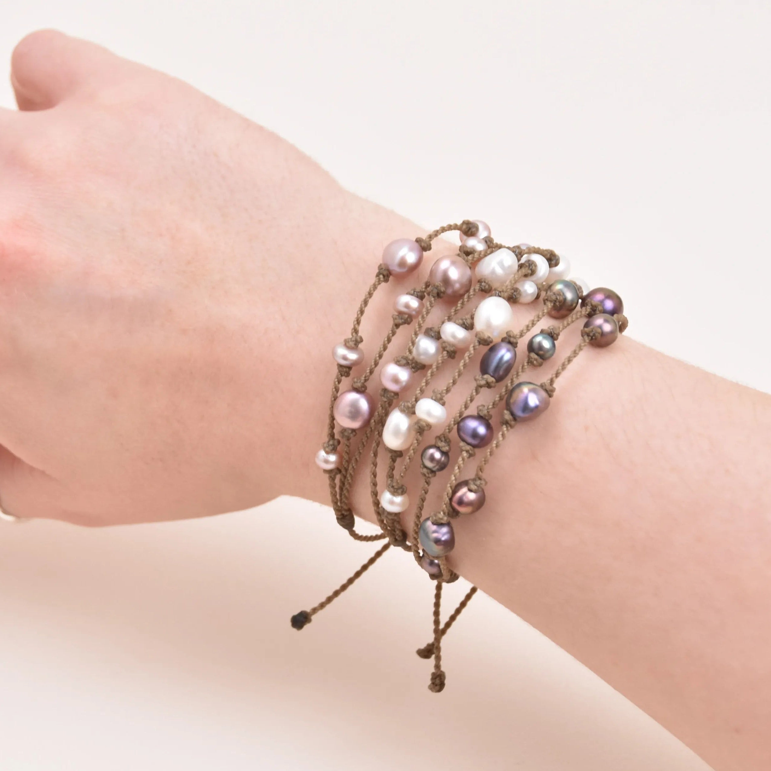 Tula Blue's Journey Bracelet in blush white and peacock on model wrist