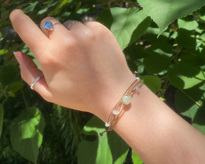 Mental Health Matters Riptide Bracelet on model's wrist in front of green leaves