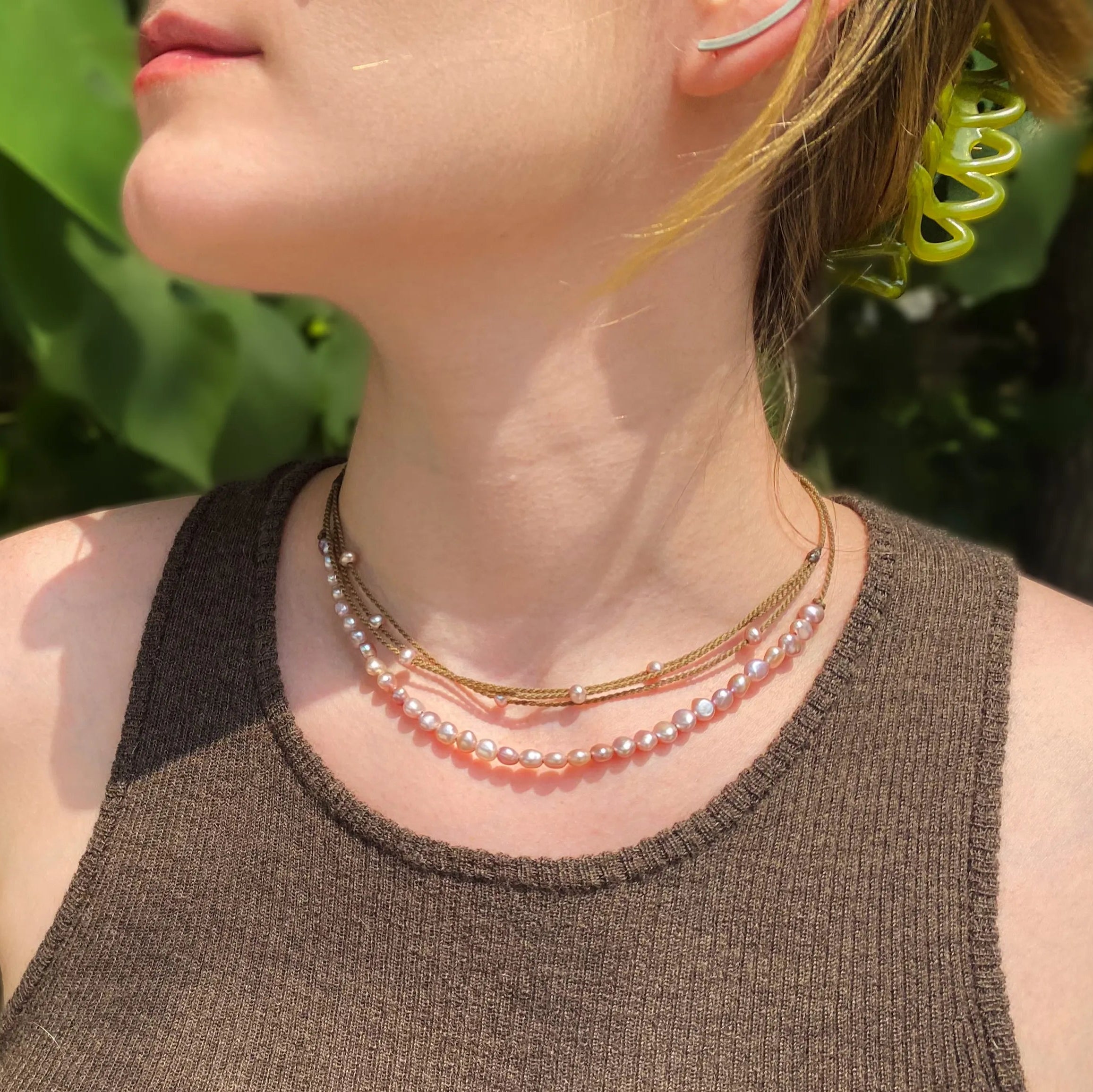 blush pearl crown necklace and blush pearl riptide necklace on model