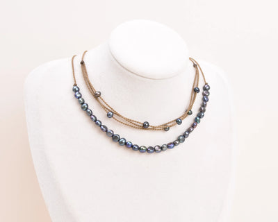 peacock pearl crown necklace and peacock pearl riptide necklace on bust