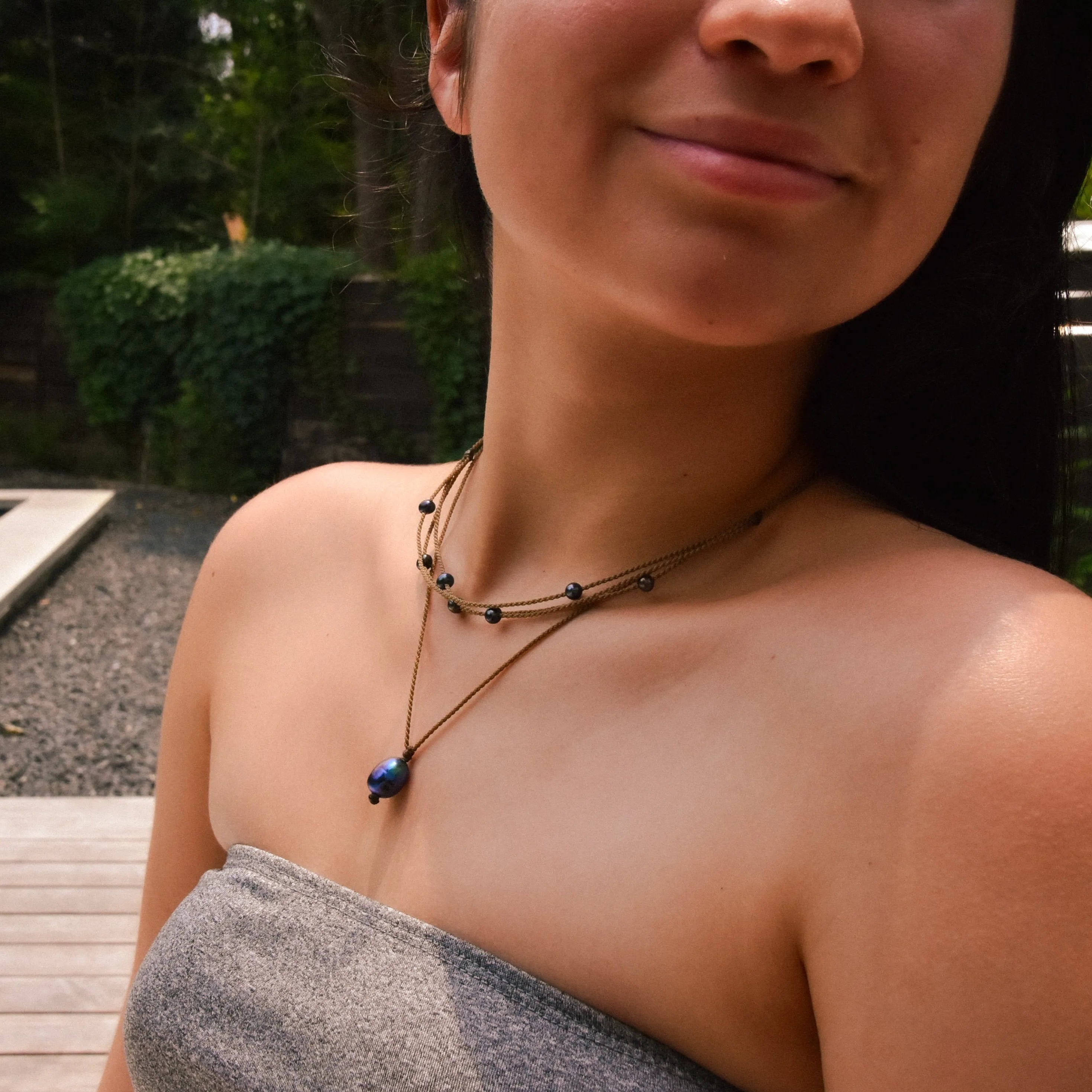 Pearl Drop Necklace in Peacock on model paired with peacock riptide necklace