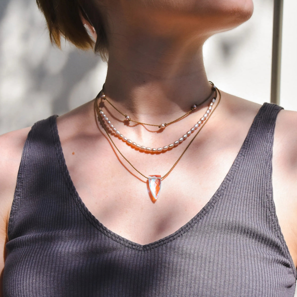 Rosy Aura Necklace Stack in blush on model with white background