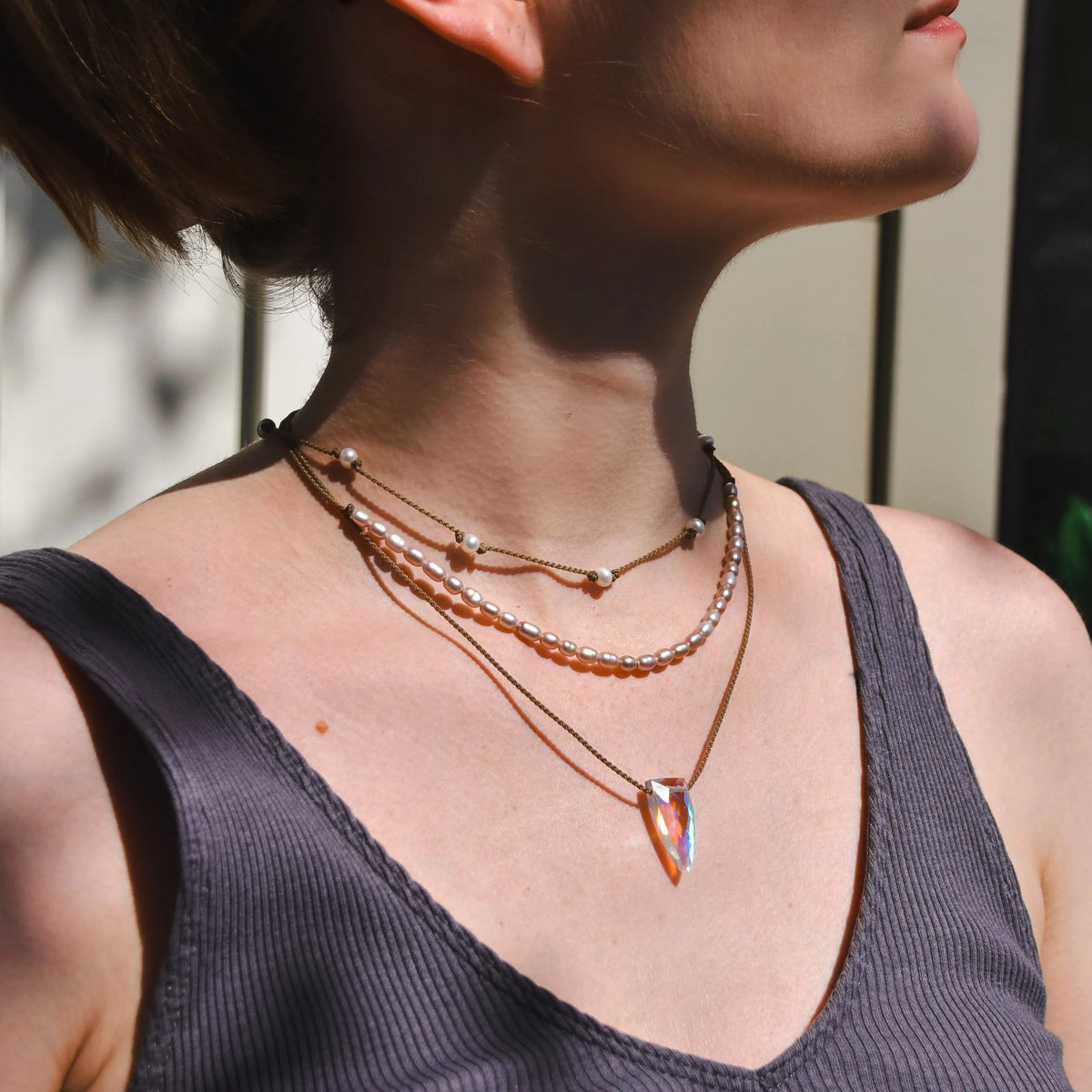 Rosy Aura Necklace Stack in white on model with white and black background 