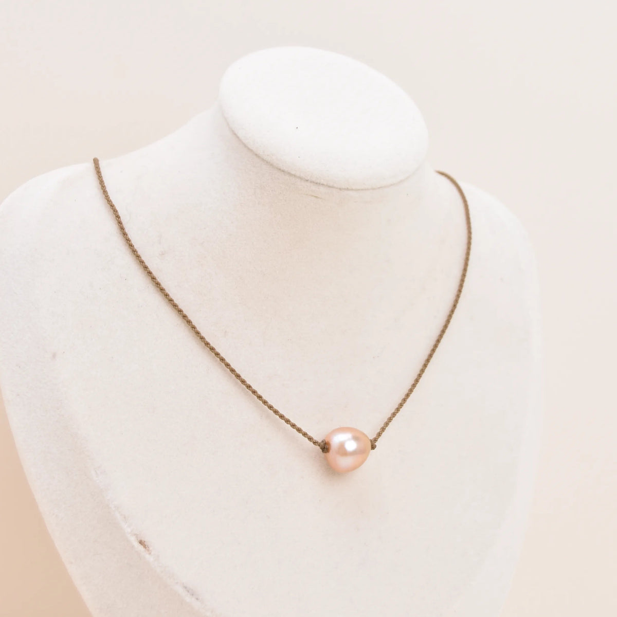 Classic Pearl Necklace with a blush pink Edison freshwater pearl knotted on hand-spun rope, displayed on a bust