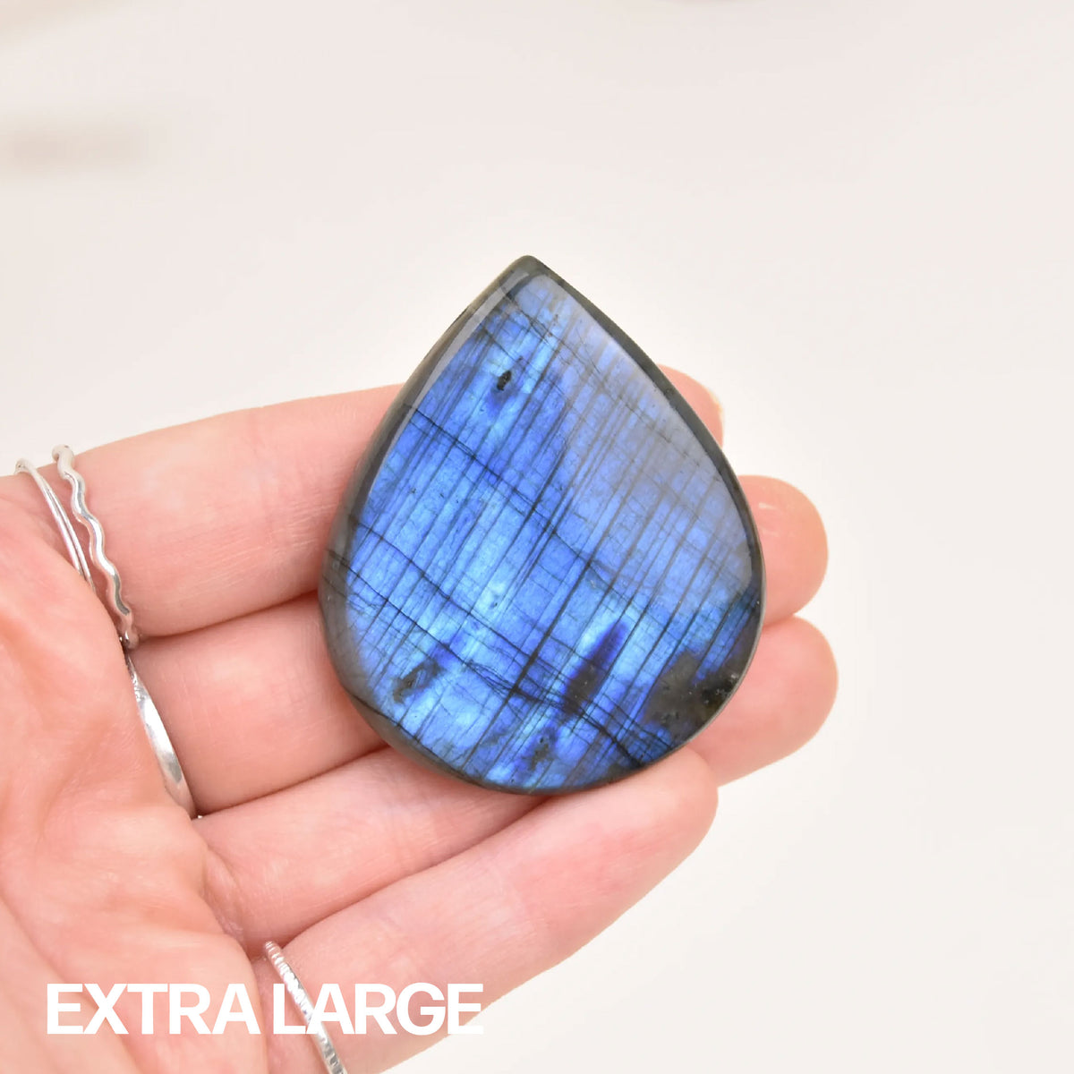 Labradorite Gemstone Pendant in size extra large, vivid blue flash stone held in hand for scale