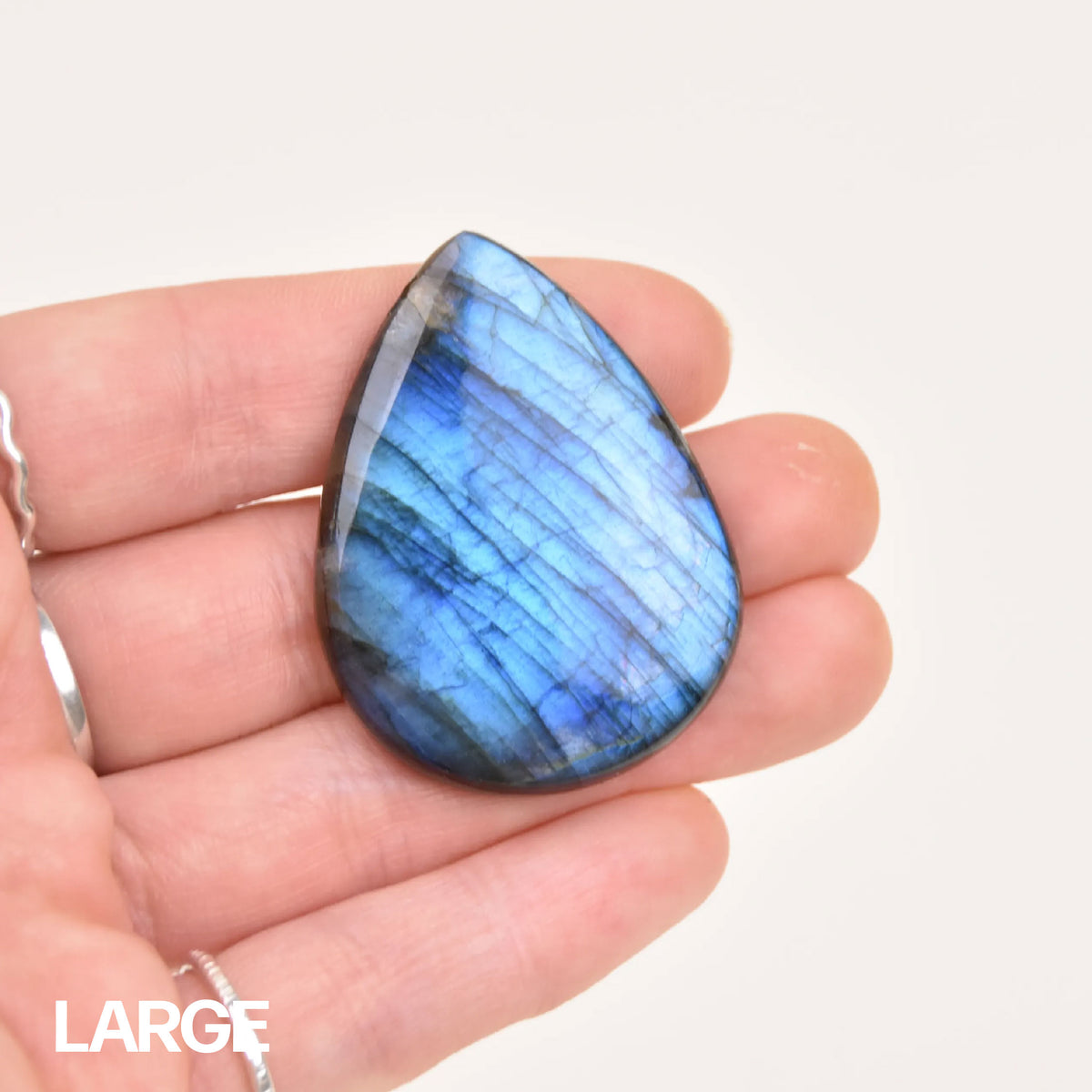 Labradorite Gemstone Pendant in size large, vivid blue flash stone held in hand for scale