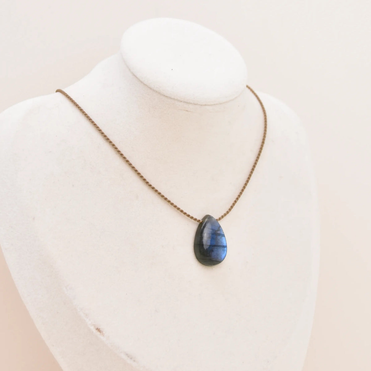 Labradorite Gemstone Pendant, small blue teardrop on hand-spun rope displayed on a white bust