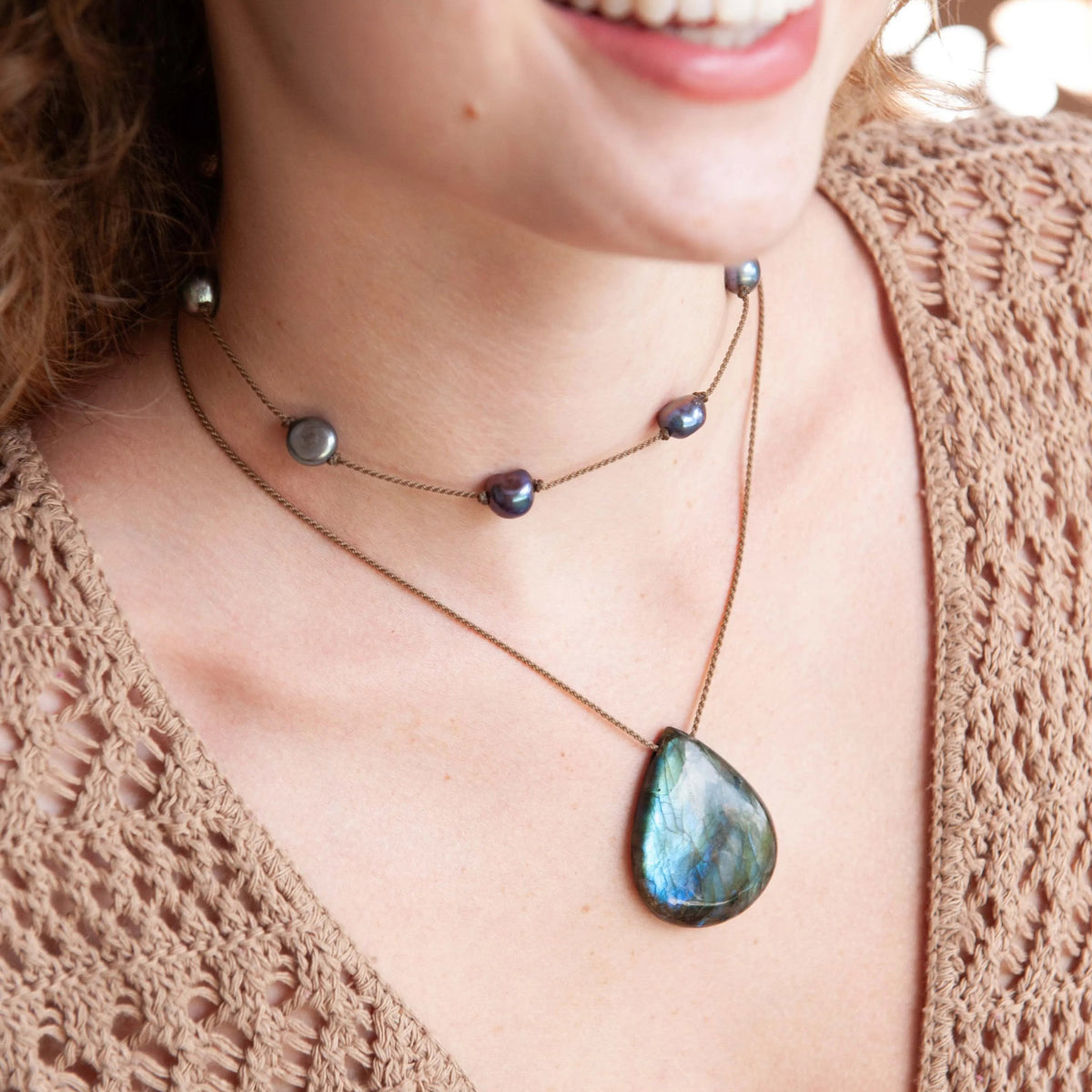 Labradorite Gemstone Pendant on hand-spun rope layered with a dark pearl necklace, tan crochet top