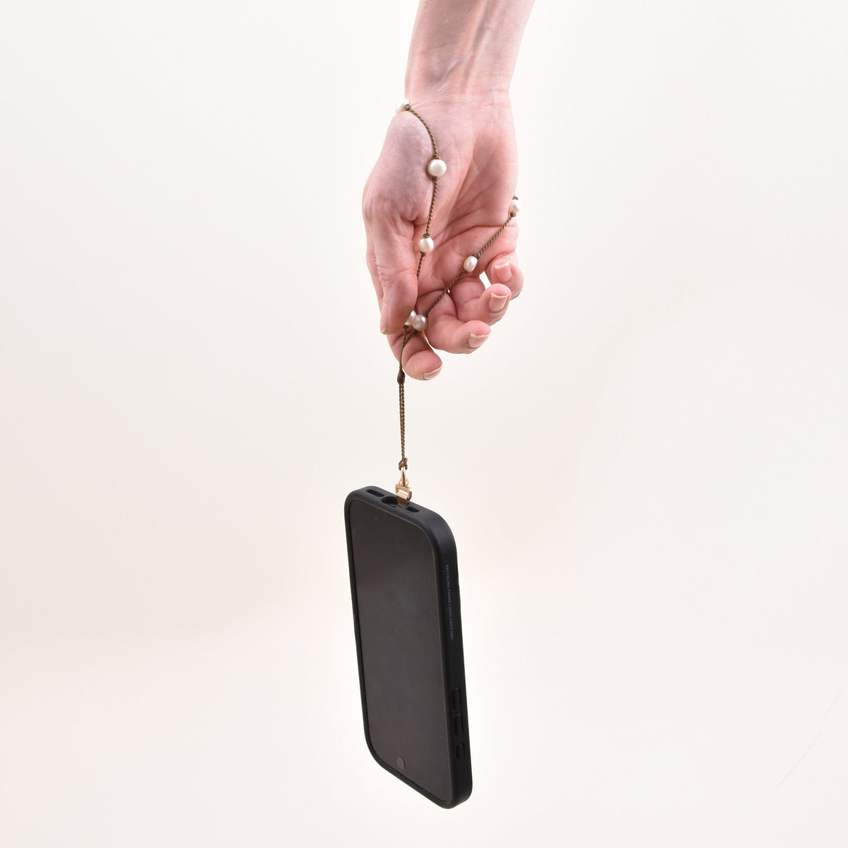 Pearl phone wristlet attached with the small metal case tab inside a phone case