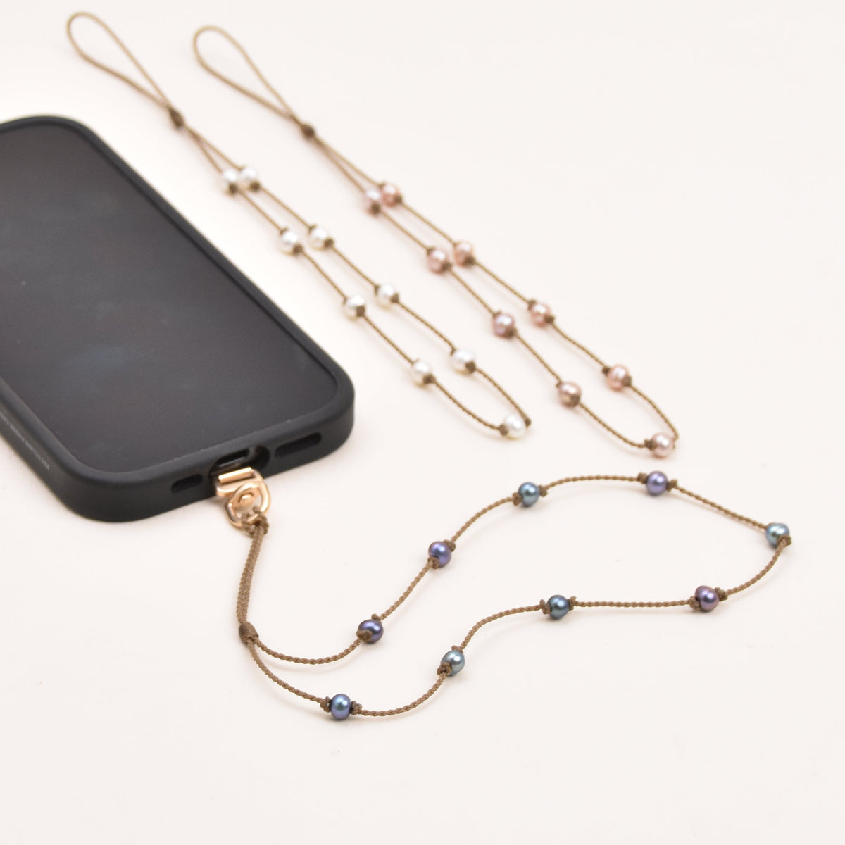 Small oval freshwater pearl phone strap on hand-spun rope
