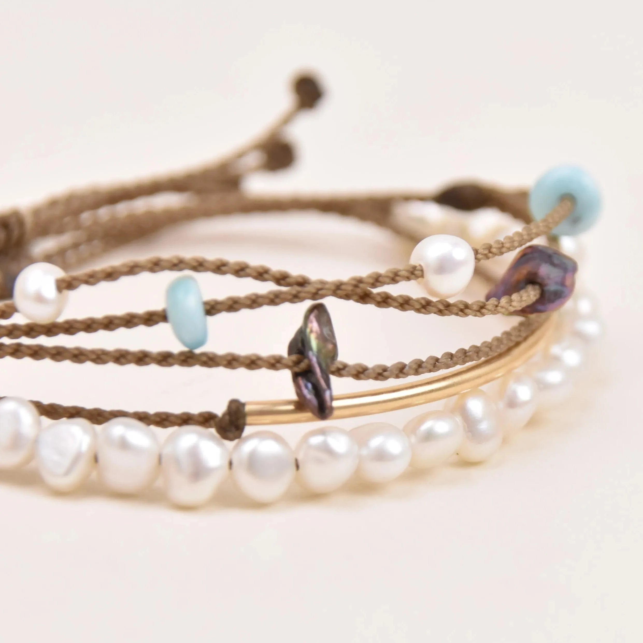 crown of the seven seas bracelet stack in white on white background 