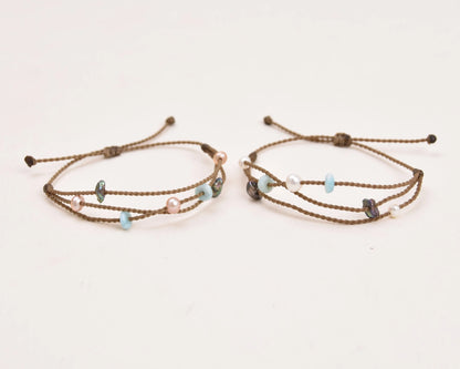 Seven Seas X PADI Riptide Bracelets with white and blush pearls on white background side by side